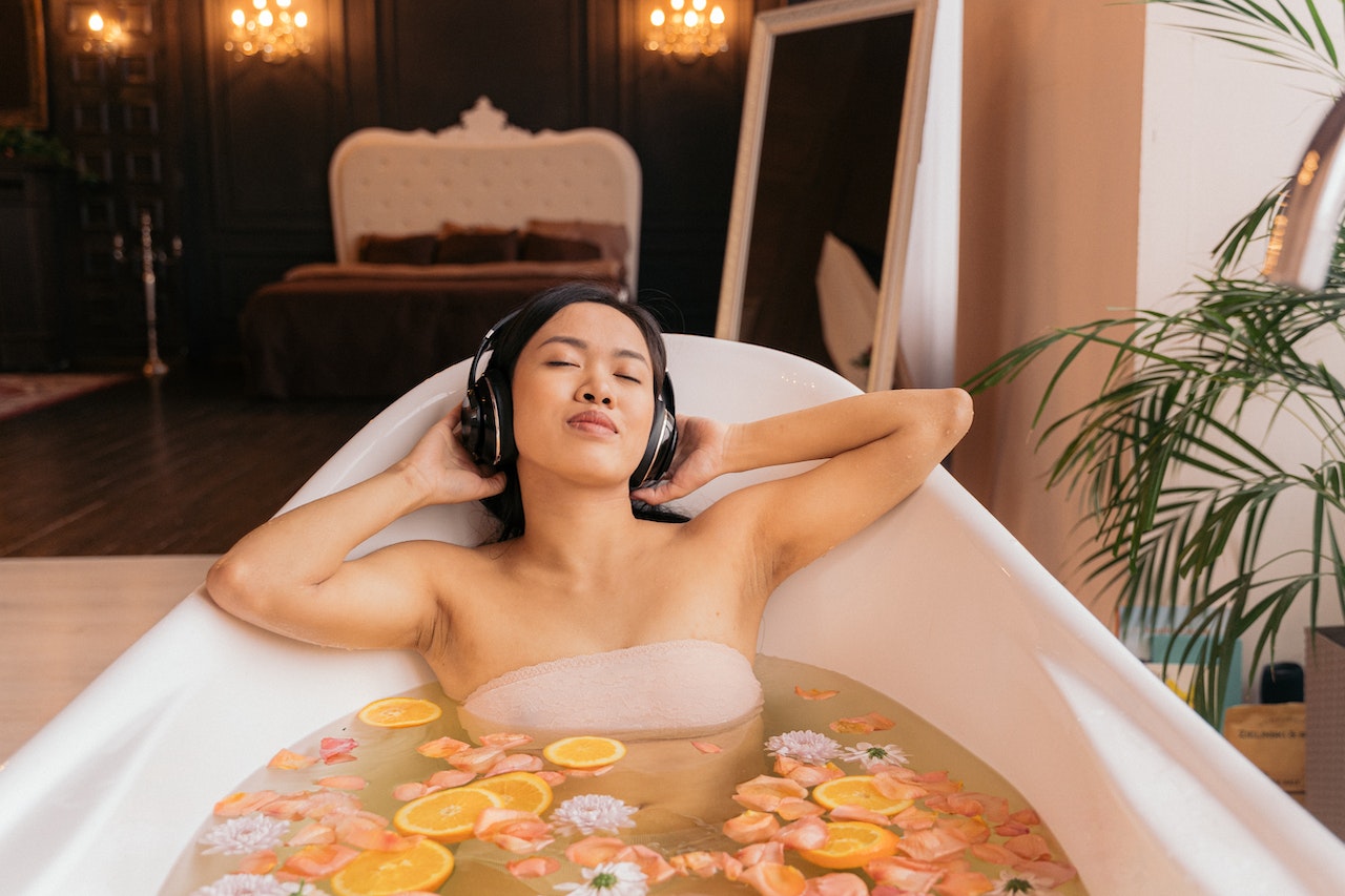 Woman listening to music while taking bath