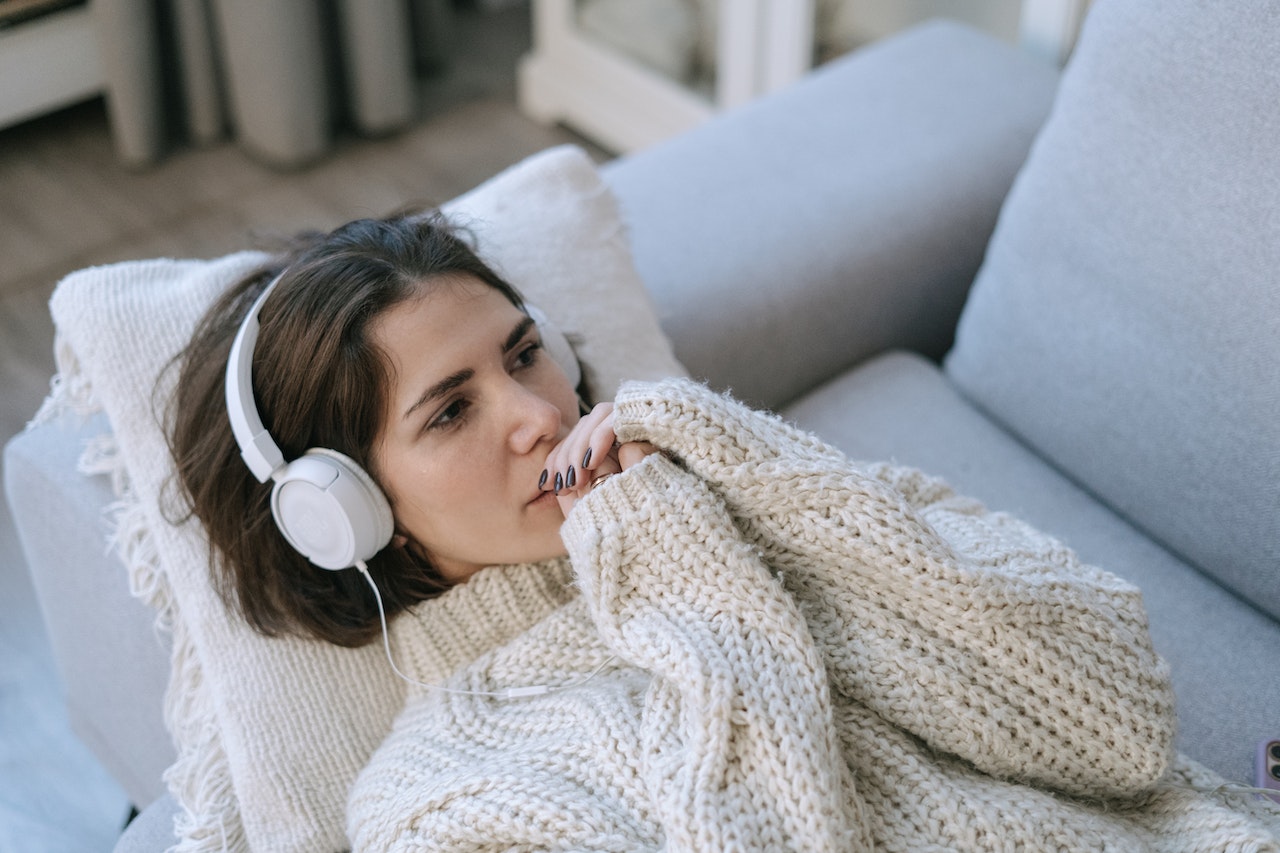 Woman trying to sleep while listening to music